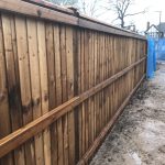 Wooden fencing being assembled in a building area. The paling fencing is perfect for securing the new properties being built.