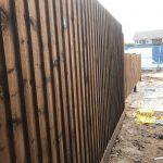 Tall wooden fencing panels stood in a fencing supply unit in Birmingham.