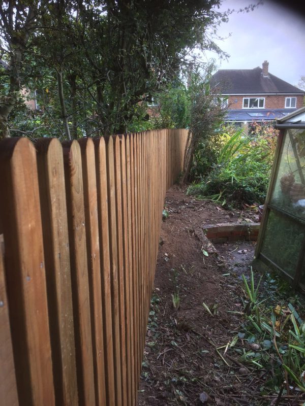 Paling wooden garden fencing surrounding a garden in Birmingham. The wooden fencing is perfect for providing security.