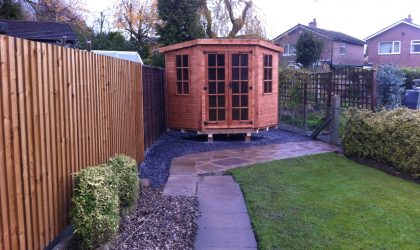 Made to measure garden shed standing in a long garden. This bespoke shed is hexagonal in shape.