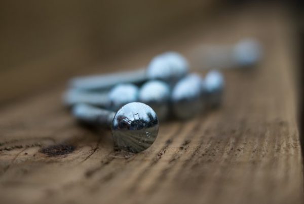 M10 Steel Coach Bolts in various sizes sitting on a wooden fence panel.