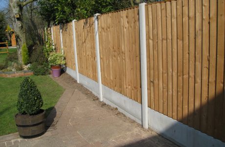 A garden in Birmingham surrounded by a fence. Fence panels are wooden with concrete posts in between.