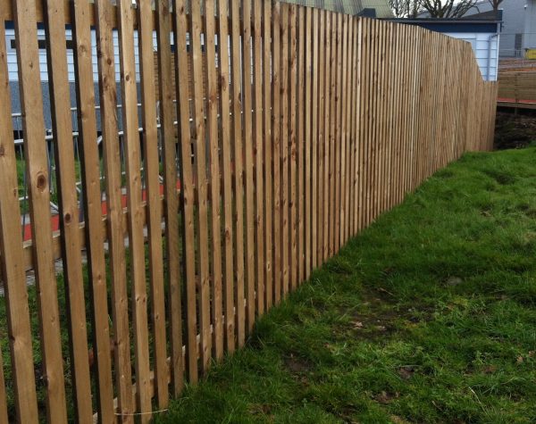 Wooden garden fencing standing in a garden in Birmingham. Paling fencing perfect for domestic use.