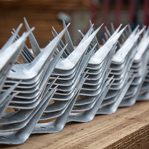 A selection of wall spikes ready to be placed on top of a commercial fence.