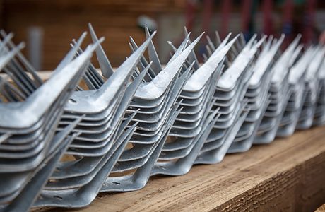 A selection of wall spikes ready to be placed on top of a commercial fence.