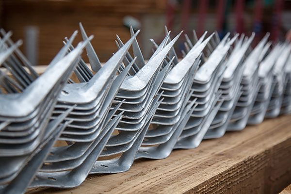 A selection of wall spikes ready to be placed on top of a commercial fence.