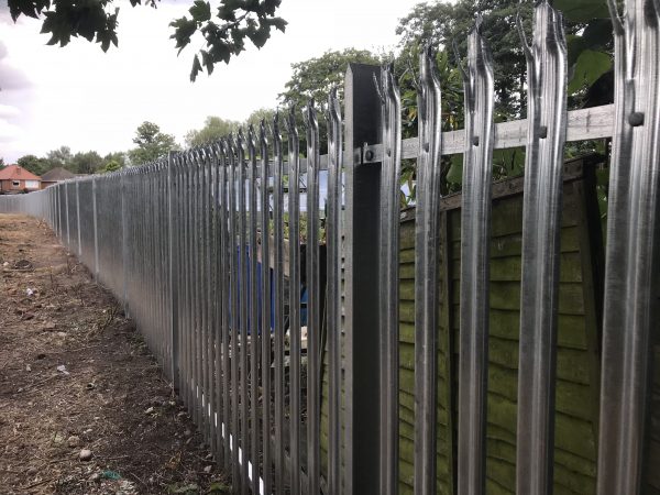 Steel commercial fencing, securing a private space.