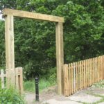 Wooden fencing and archway in front of a park in Birmingham.