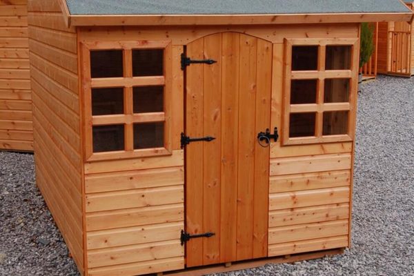 Made to measure garden shed standing in a garden. This bespoke shed has two windows and a door.