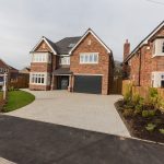 A new build house with paling fencing alongside.