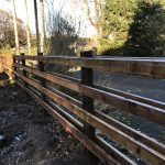 Commercial post and rail fencing standing in a public open space in Birmingham.