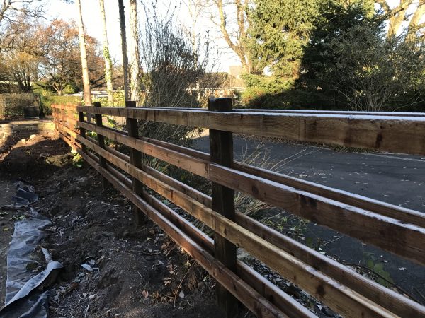 Commercial post and rail fencing standing in a public open space in Birmingham.