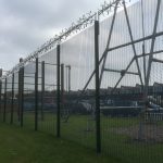 Green double mesh fencing with security spikes. This commercial fencing solution is perfect for security purposes.