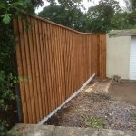 Wooden fence with feather edge fence capping.