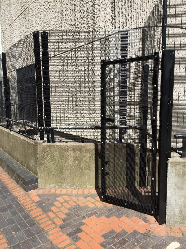 Black mesh fencing providing security for commercial buildings.