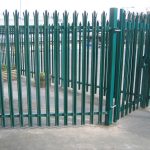 Green steel palisade fencing providing security for a commercial buildings in Birmingham.