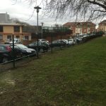 Double mesh fencing surrounding a car park. Commercial fencing provides security for different properties and areas.