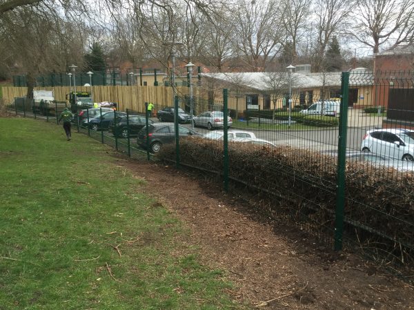 Double mesh fencing being assembled around a car park in Birmingham. Commercial fences offer a great security solution.