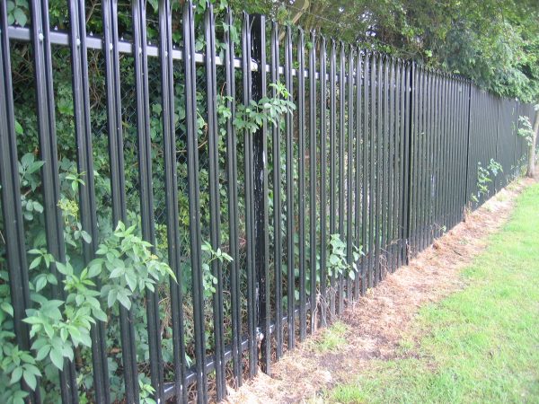 Back steel palisade fencing. Commercial fencing provides a quality security solution.