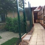 Green double mesh fencing. This commercial fencing is perfect for securing office buildings.