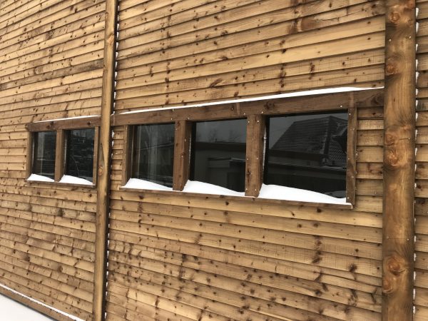 A commercial shed with five glass windows.