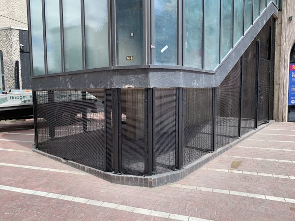 Commercial fencing being assembled around a property in Birmingham. Double wire mesh provides a secure option for businesses.