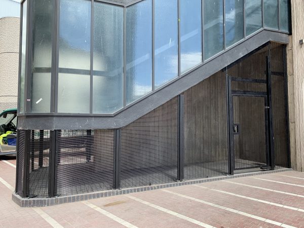 Double mesh fencing surrounding a commercial building. The commercial fence offers security for businesses and institutions.