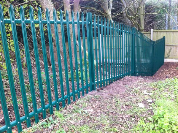 Green steel palisade fencing providing security for a private area in Birmingham.