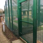 Green double mesh fencing. Commercial fencing provides a secure security solution.