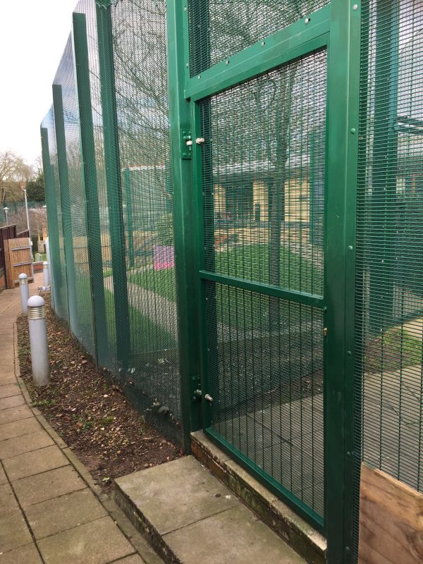 Green double mesh fencing. Commercial fencing provides a secure security solution.