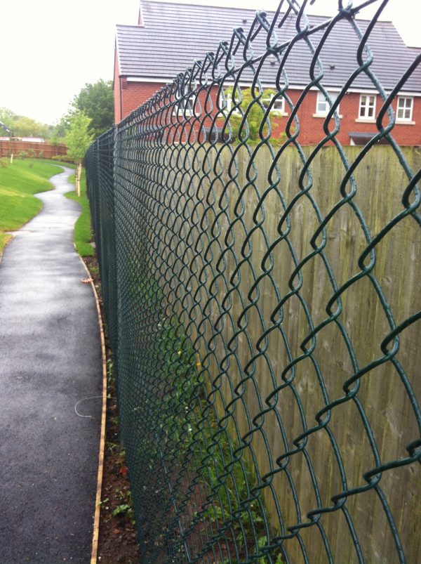 Green chain link fencing used for commercial purposes.