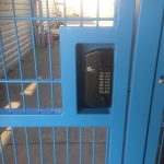 Blue wire mesh gates with secure coded lock.
