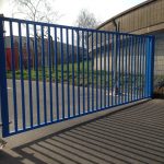 Blue vertical bar steel gate. Commercial gates used to secure a commercial property,