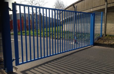 Blue vertical bar steel gate. Commercial gates used to secure a commercial property,