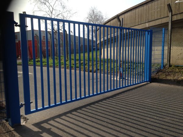 Blue vertical bar steel gate. Commercial gates used to secure a commercial property,