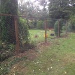 Chain link fencing with wooden fence posts. Commercial fencing provides a quality security solution.