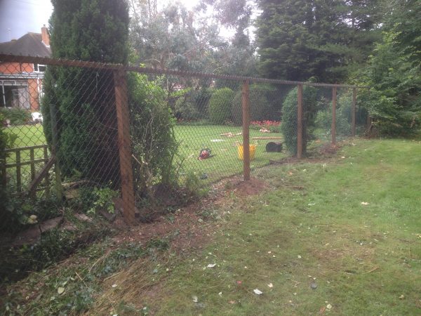 Chain link fencing with wooden fence posts. Commercial fencing provides a quality security solution.