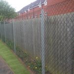 Chain link fencing alongside a public walk way. Commercial fencing provides quality security.