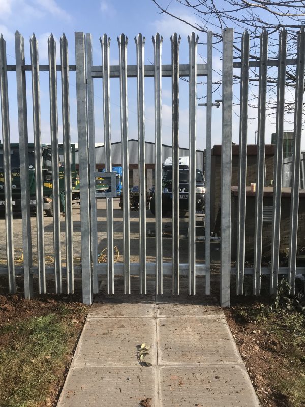 Steel palisade gates in front of an industrial unit. These commercial gates are perfect to keep industrial areas secure.