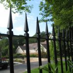 Black steel bespoke railings. These bespoke railings surround a large garden giving it a high quality finish.