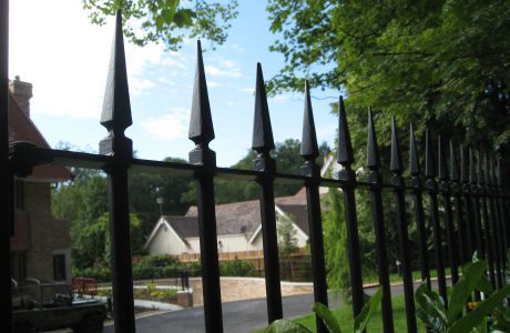 Black steel bespoke railings. These bespoke railings surround a large garden giving it a high quality finish.