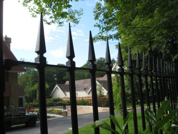 Black steel bespoke railings. These bespoke railings surround a large garden giving it a high quality finish.