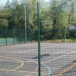 Multiple use games area in a school are park yard. Sport area fit with goal posts and basketball nets.