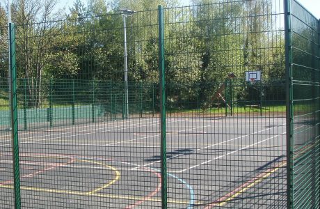 Multiple use games area in a school are park yard. Sport area fit with goal posts and basketball nets.