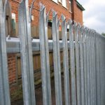 Steel palisade fencing used to secure a commercial building.