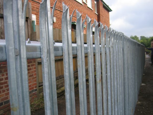 Steel palisade fencing used to secure a commercial building.