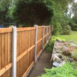 A long wooden fence in a garden in Birmingham. The fence has close board fence panels.
