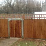 Tall wooden fence. The fence has t type timber trellis fencing panels.