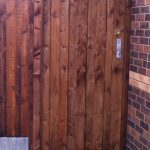 A wooden gate with feather edge boards and a pre-clad timber gate frame.