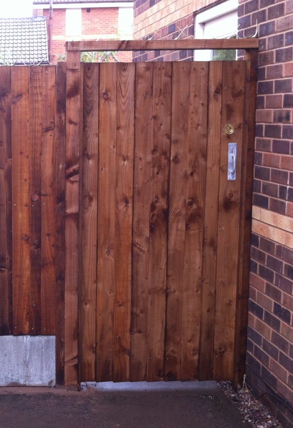 A wooden gate with feather edge boards and a pre-clad timber gate frame.